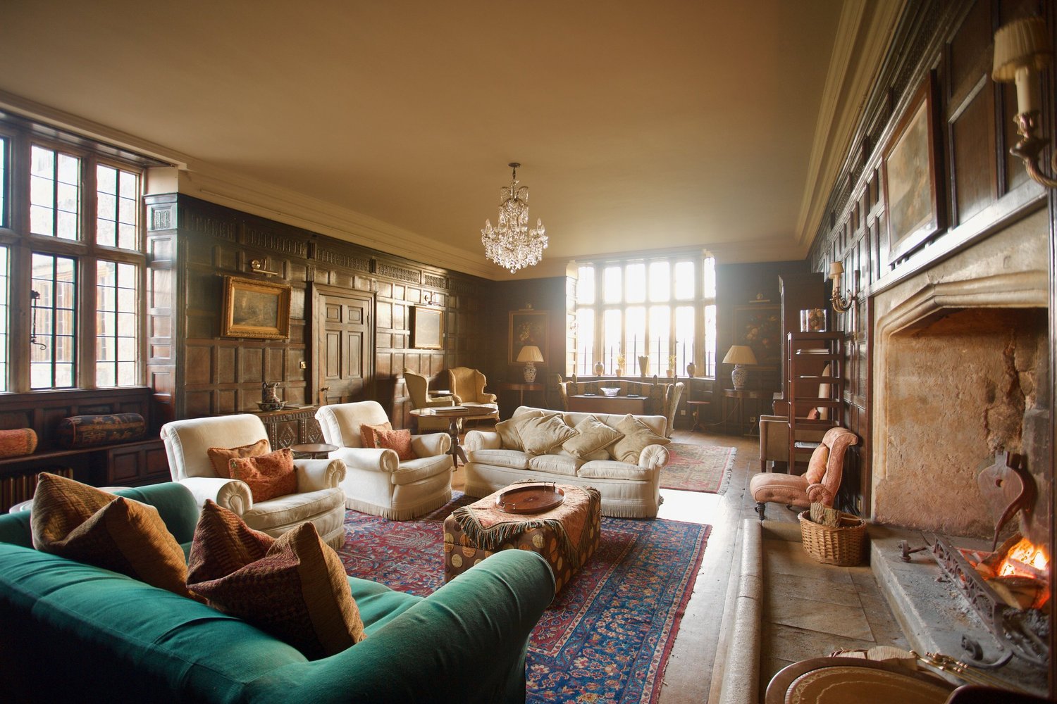 The panelled great hall of the retreat house with a large open fireplace