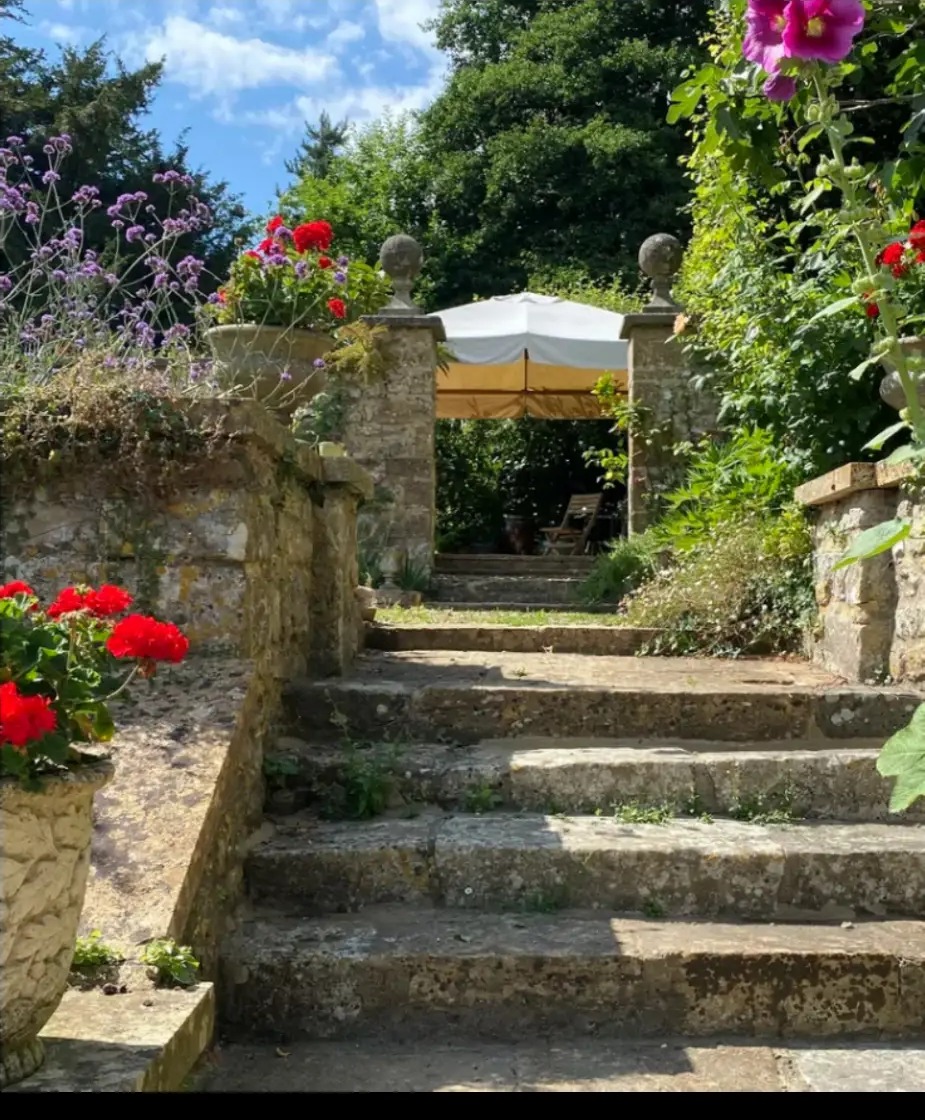 Stone garden steps leading up through the retreat house grounds to a shaded seating area