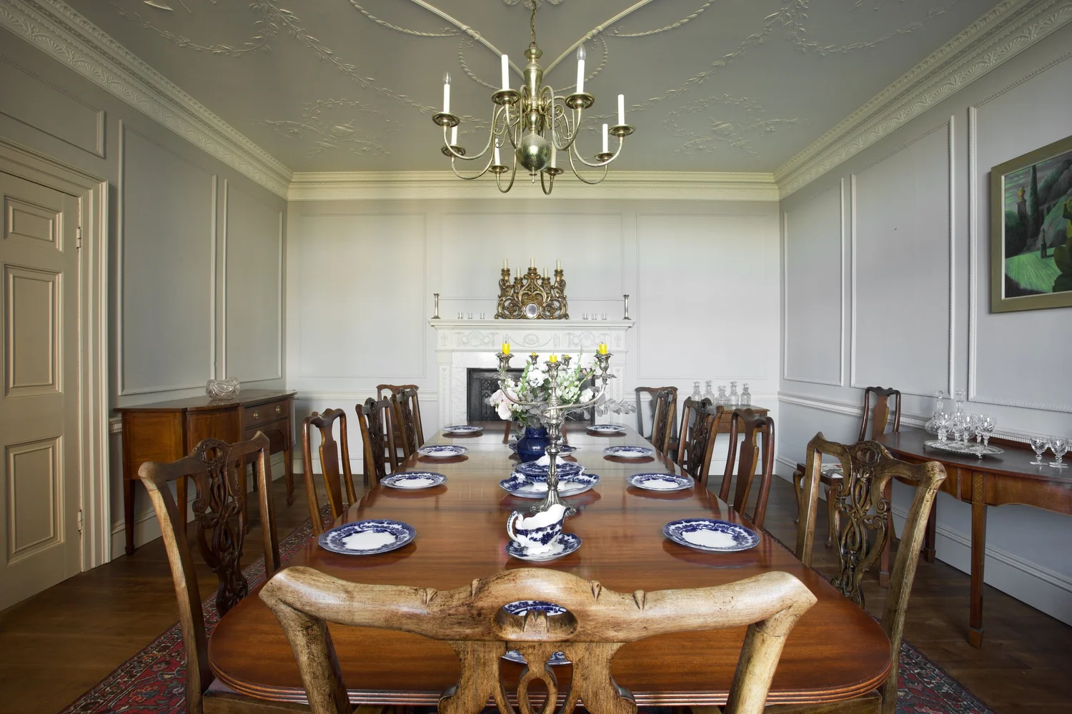 The long dining room of the house, laid for a shared meal