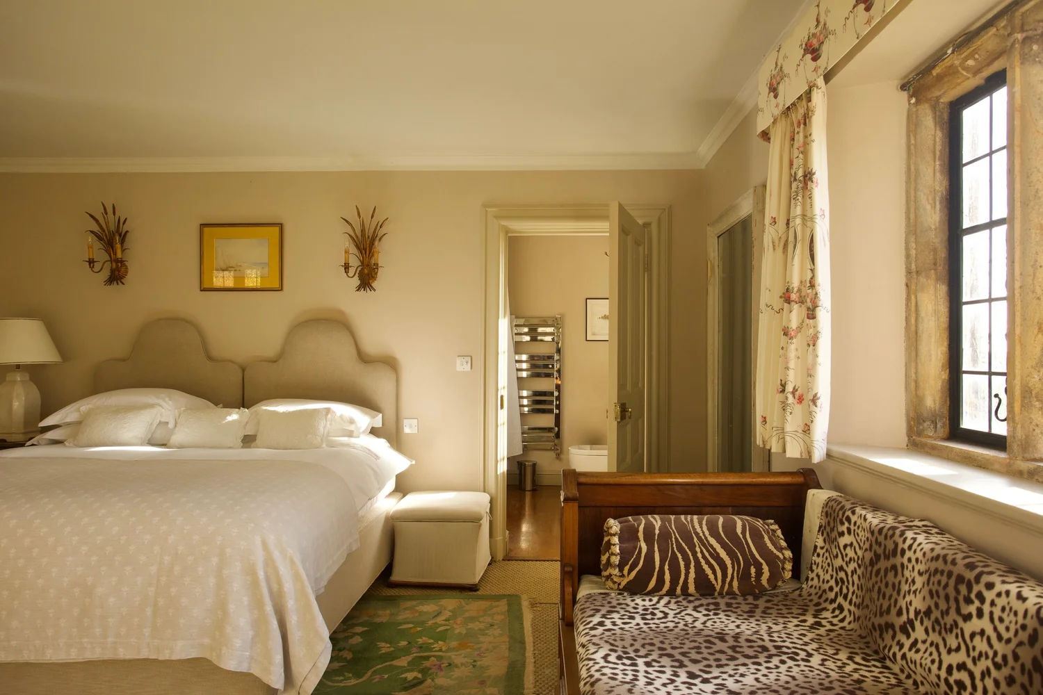 A light, elegant bedroom with period furniture and countryside views